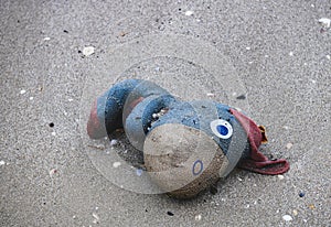 Discard garbage old fabric doll on the beach