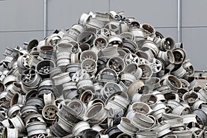 Discarded Aluminum Wheels in Recycling Industry. Stack of old discarded wheels, metal recycling industry