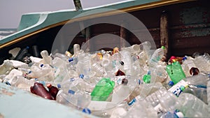 Discarded bottles clutter derelict vessel boat, beach backdrop marine rubbish issue. Accumulation neglect, impact on