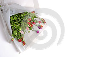 Discarded bouquet of decorative roses, dried flowers on a white, background