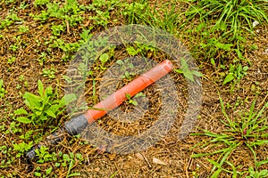 Discarded broken red plastic traffic wand