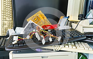 Discarded computer spare parts. E-waste pile detail from hardware