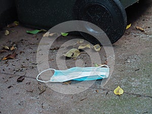 Discarded face mask on the ground - pollution caused by the covid19 pandemic