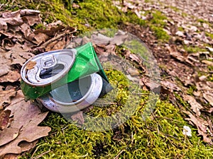 Discarded green aluminium beer or soda can in a forest