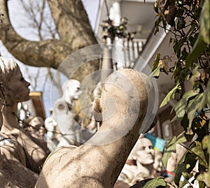 discarded mannequins at a backyard with one looking back