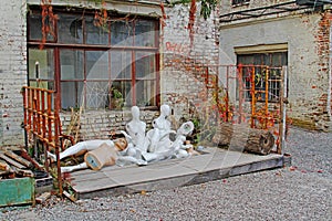 Discarded nude mannequins in junkyard.