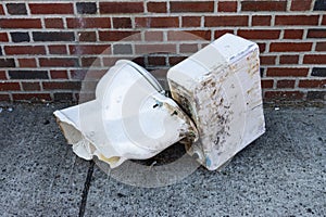 Discarded Old White Porcelain Toilet on a New York City Sidewalk