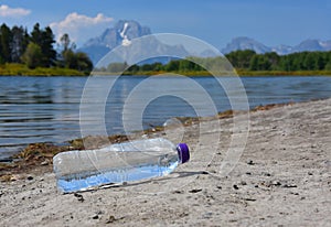 Discarded plastic bottle of water litters a beauty spot