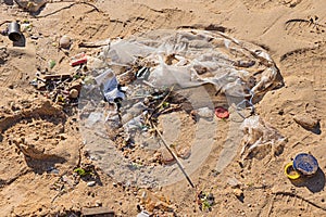 Discarded plastic garbage by wave at beach