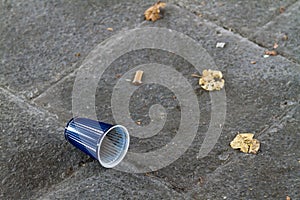 Discarded plastic takeaway cup on a sidewalk