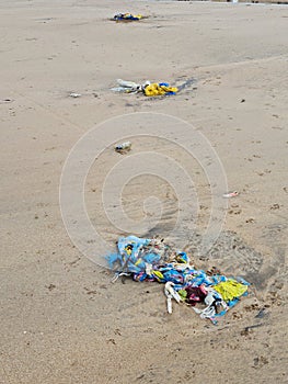 Discarded plastic waste pollution on sea beach endangering marine life