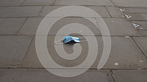 Discarded protective face mask on a street