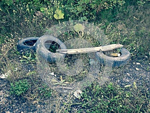 Discarded tires in the forest. Forest pollution
