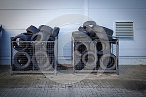 discarded tires are stored in boxes at a car repair shop