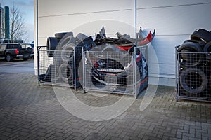 discarded tires are stored in boxes at a car repair shop