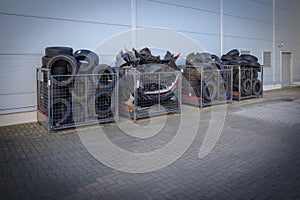 discarded tires are stored in boxes at a car repair shop