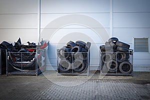 discarded tires are stored in boxes at a car repair shop