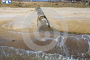 Discharge of dirty industrial wastewater in sea on city beach. Poisoning of recreation areas by spread of diseases, destruction of