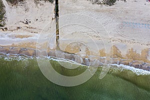 Discharge of dirty industrial wastewater in sea on city beach. Poisoning of recreation areas by spread of diseases, destruction of