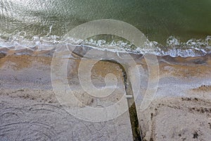 Discharge of dirty industrial wastewater in sea on city beach. Poisoning of recreation areas by spread of diseases, destruction of