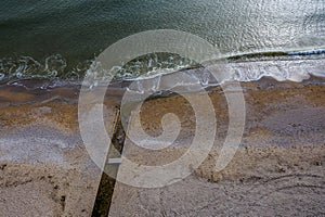 Discharge of dirty industrial wastewater in sea on city beach. Poisoning of recreation areas by spread of diseases, destruction of