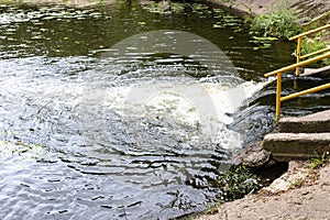 Discharge of water from underground river in pond