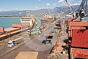 Discharging of cargo scrap metal from cargo ship in the port of Iskenderun, Turkey. A close-up view of cargo residues on the deck