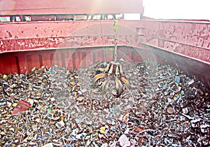 Discharging of cargo scrap metal from cargo ship in the port of Iskenderun, Turkey. A close-up view of cargo residues on the deck