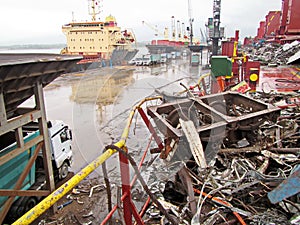 Discharging of cargo scrap metal from cargo ship in the port of Iskenderun, Turkey. A close-up view of cargo residues on the deck