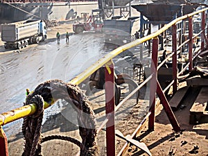 Discharging of cargo scrap metal from cargo ship in the port of Iskenderun, Turkey. A close-up view of cargo residues on the deck