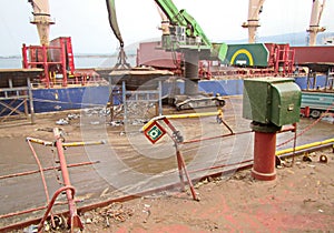 Discharging of cargo scrap metal from cargo ship in the port of Iskenderun, Turkey. A close-up view of cargo residues on the deck