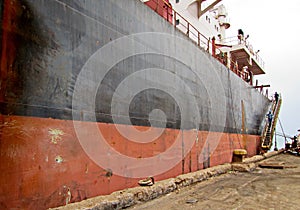Discharging of cargo scrap metal from cargo ship in the port of Iskenderun, Turkey. A close-up view of cargo residues on the deck
