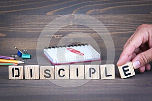 Disciple from wooden letters on wooden background