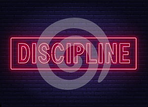 Discipline neon sign on dark background.