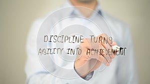 Discipline Turns Ability into Achievement, man writing on transparent screen