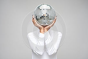 disco anonymous charming glimmer young woman holding a disco ball in front of her head