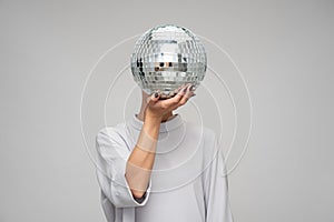 disco anonymous charming glimmer young woman holding a disco ball in front of her head