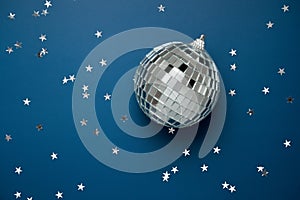 disco ball on blue background with silver stars