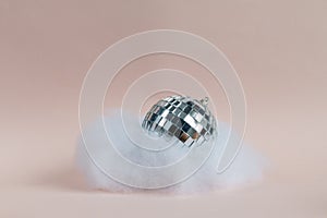 Disco ball in an imitated cloud, pink background,