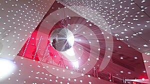 Disco ball at the New Year party, people having fun in the background