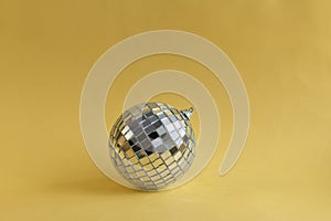 Disco ball with sparkle on golden background