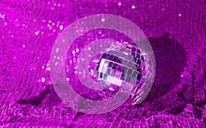 Disco ball on trendy background violet w sparkles and bokeh. Template holiday design, new year, christmas, party