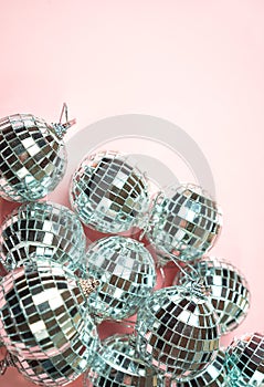 Disco balls for decoration party on pastel pink gradient background. Winter New Years Eve party holiday concept. top view, flat