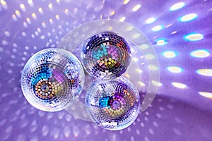 Disco balls with mirror reflections and lights at a night party in a bar or club