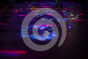 Disco in club. Dance floor in colored spots. Light music in club