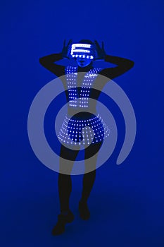 Disco dancer moves in UV ultraviolet suit.