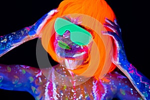 Disco dancer in neon light. Fashion model woman in neon light, portrait of beautiful model girl with fluorescent make-up