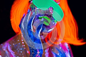 Disco dancer in neon light. Fashion model woman in neon light, portrait of beautiful model girl with fluorescent make-up
