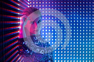 Disco dancer in neon light in night club. Fashion model woman in neon light