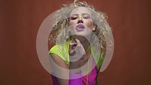 Disco diva seductively luring and licking her teeth, slow motion